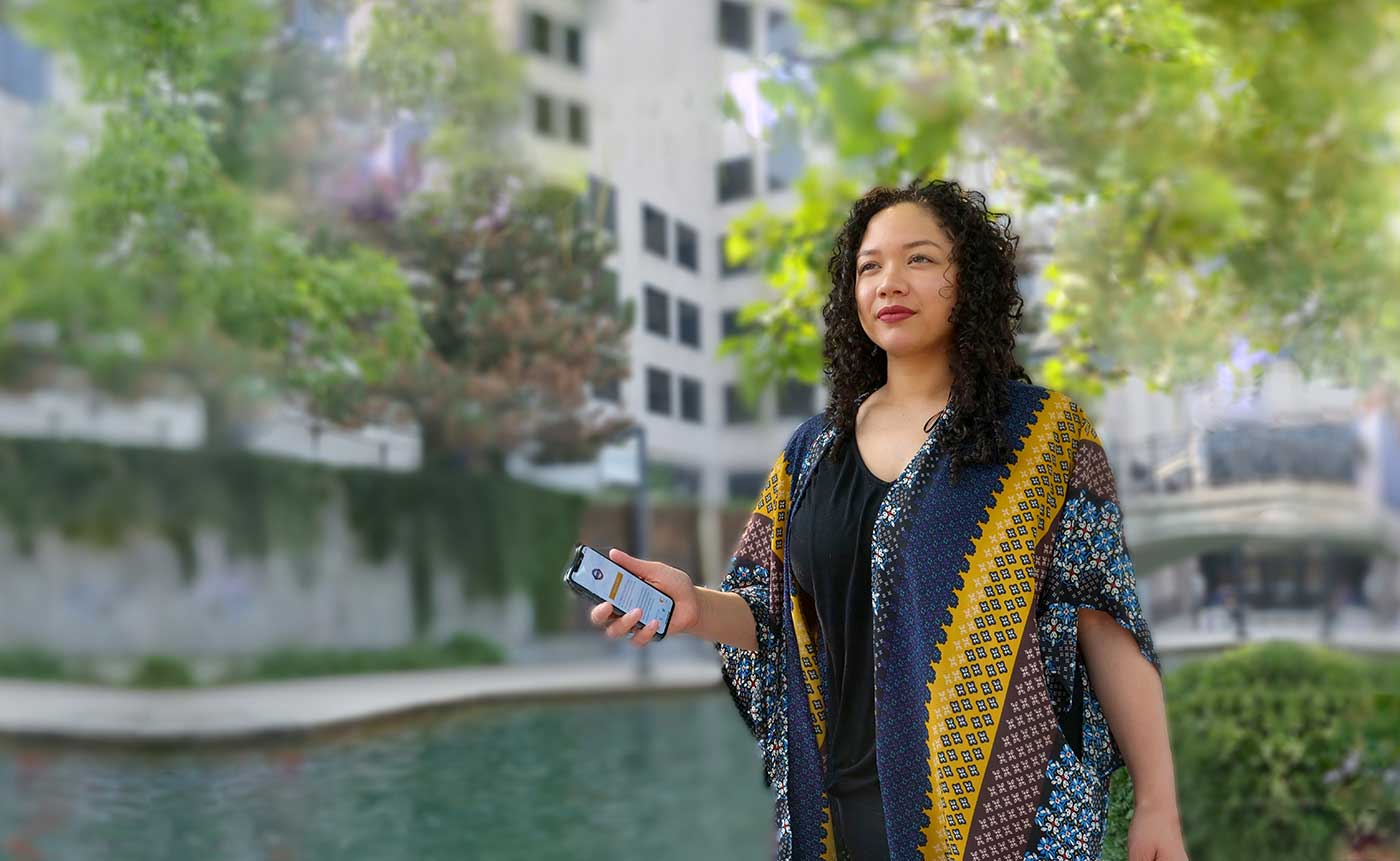 Girl is holding phone showing covert alert app